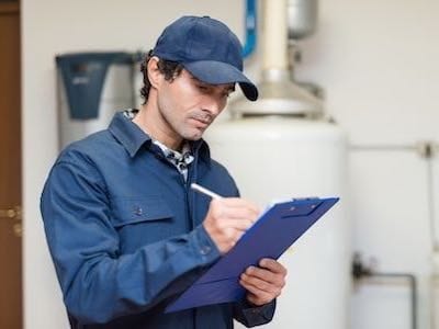 A photo of a plumber longview tx working on a plumbing inspection.