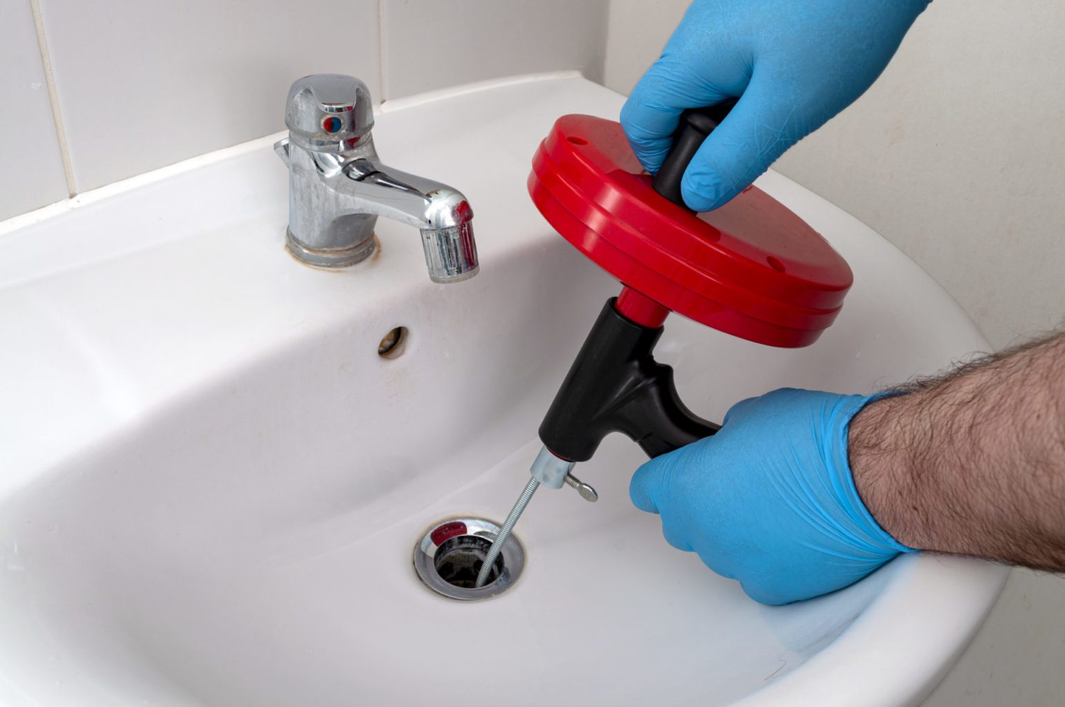 Use a plumber's snake to unclog the sink.