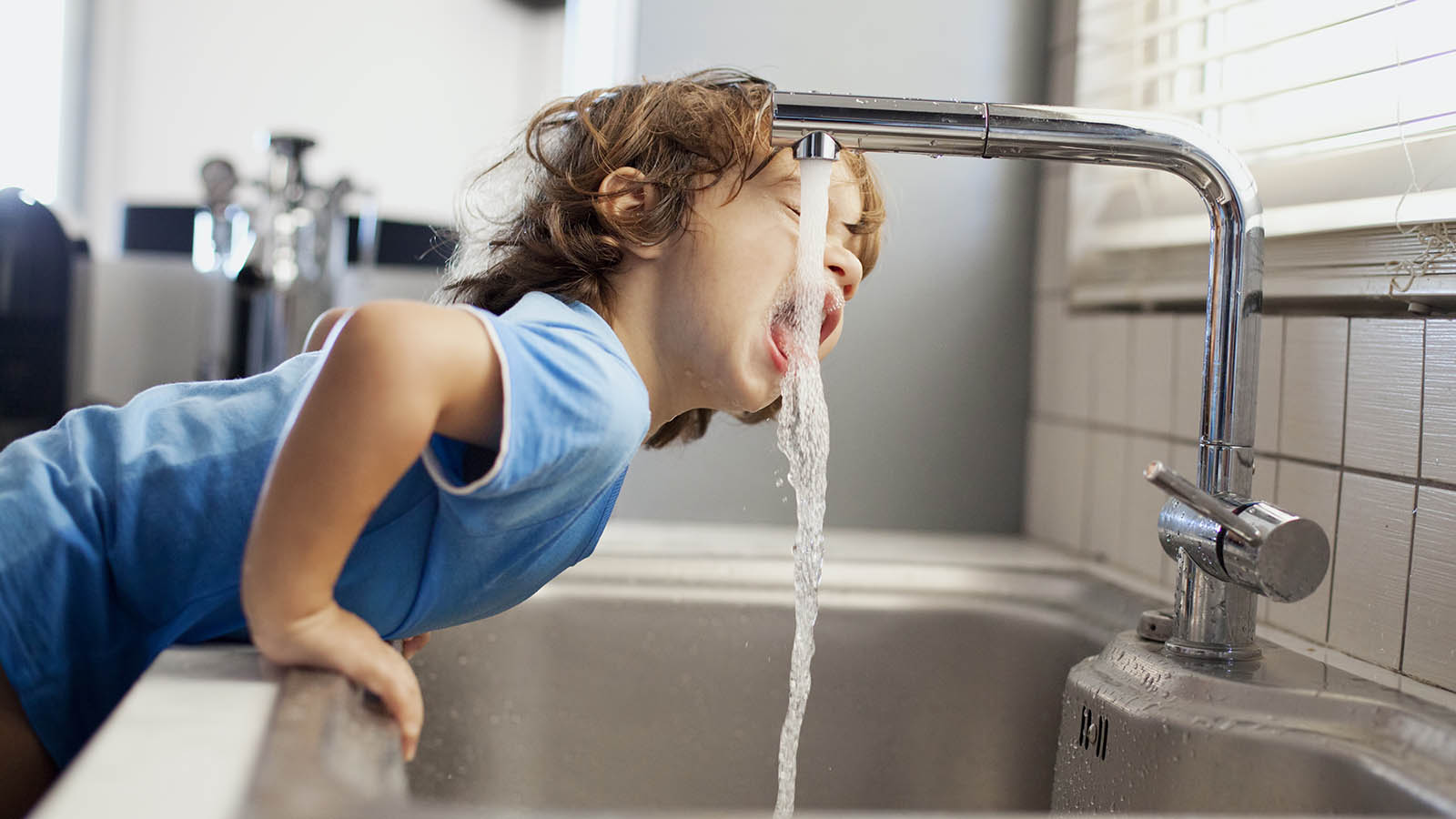 boy drinking water Small boy drinking soft water